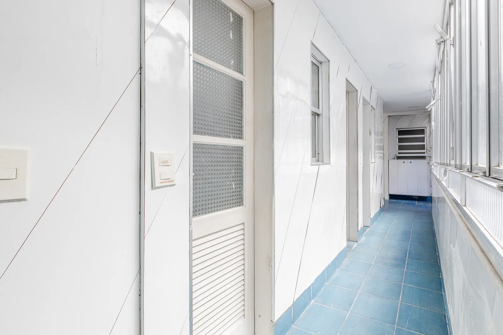 A service corridor with a blue floor