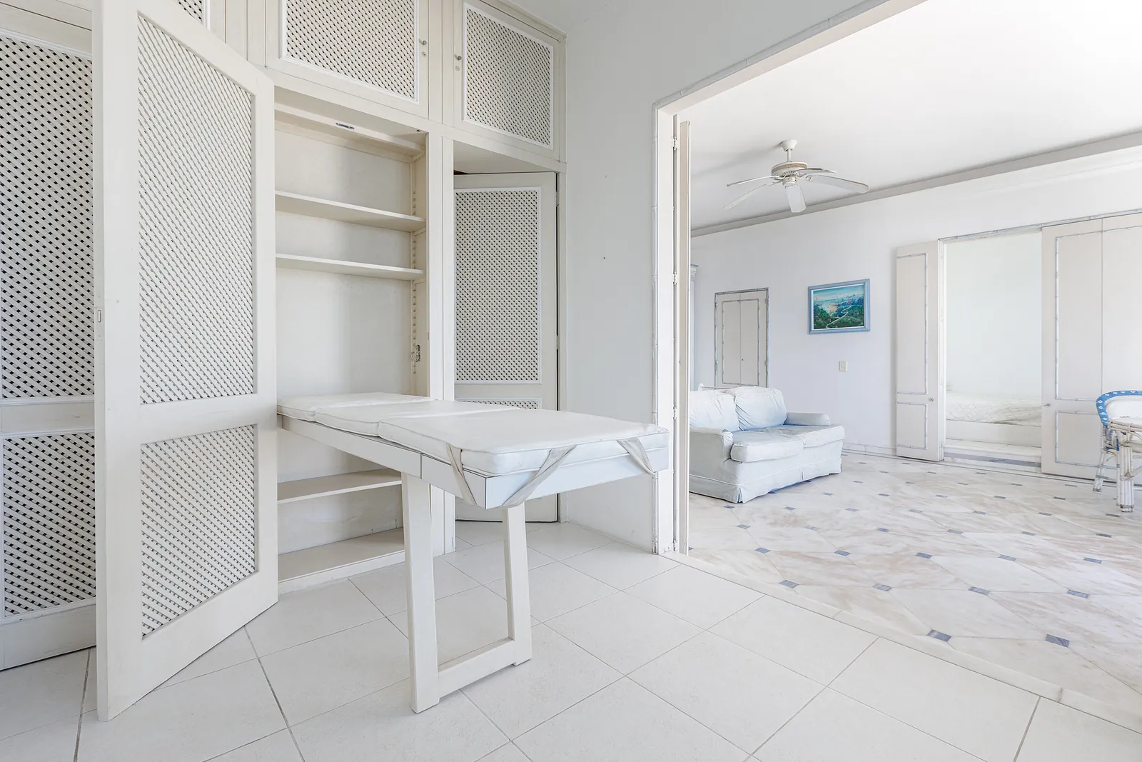 A room fitted with a carved screen and built-in storage