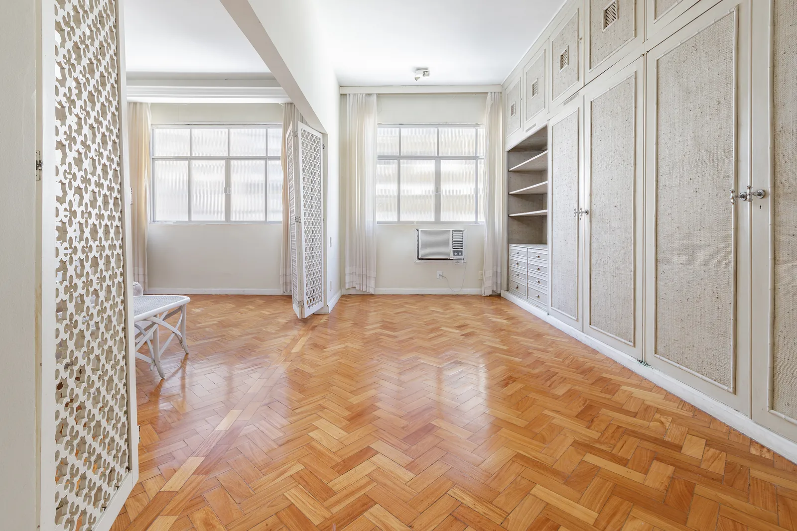 A dressing area with fitted wardrobes along the wall