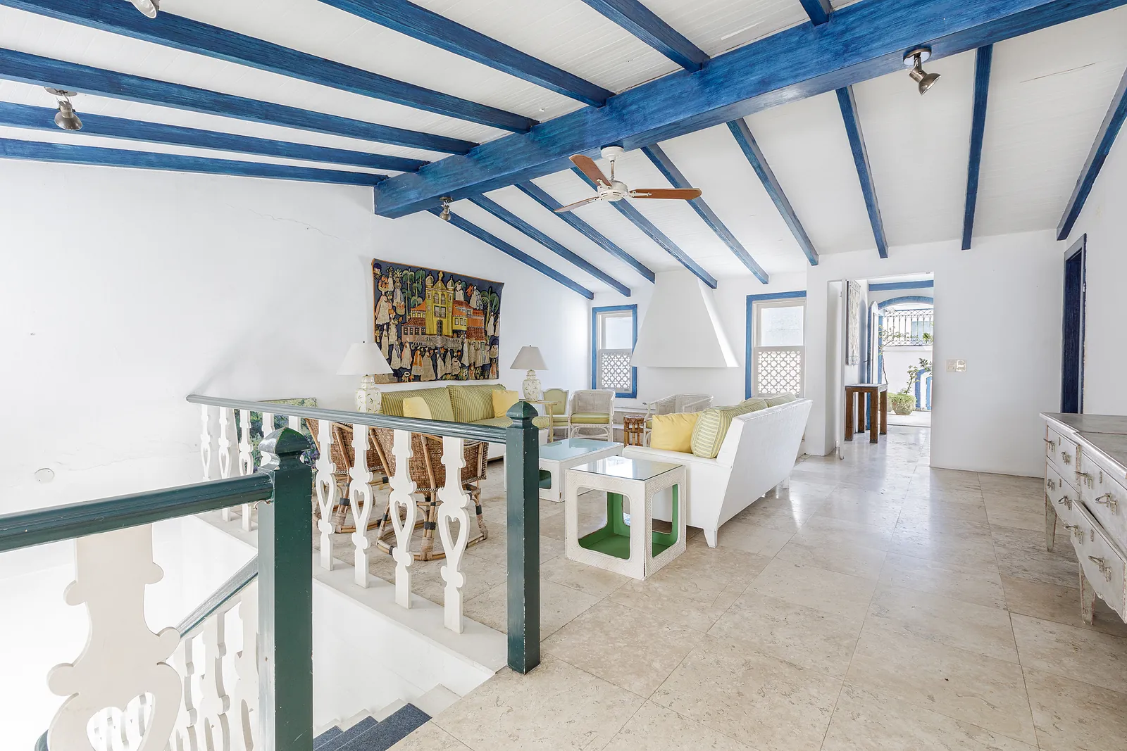 A living room with a first-floor balustrade above