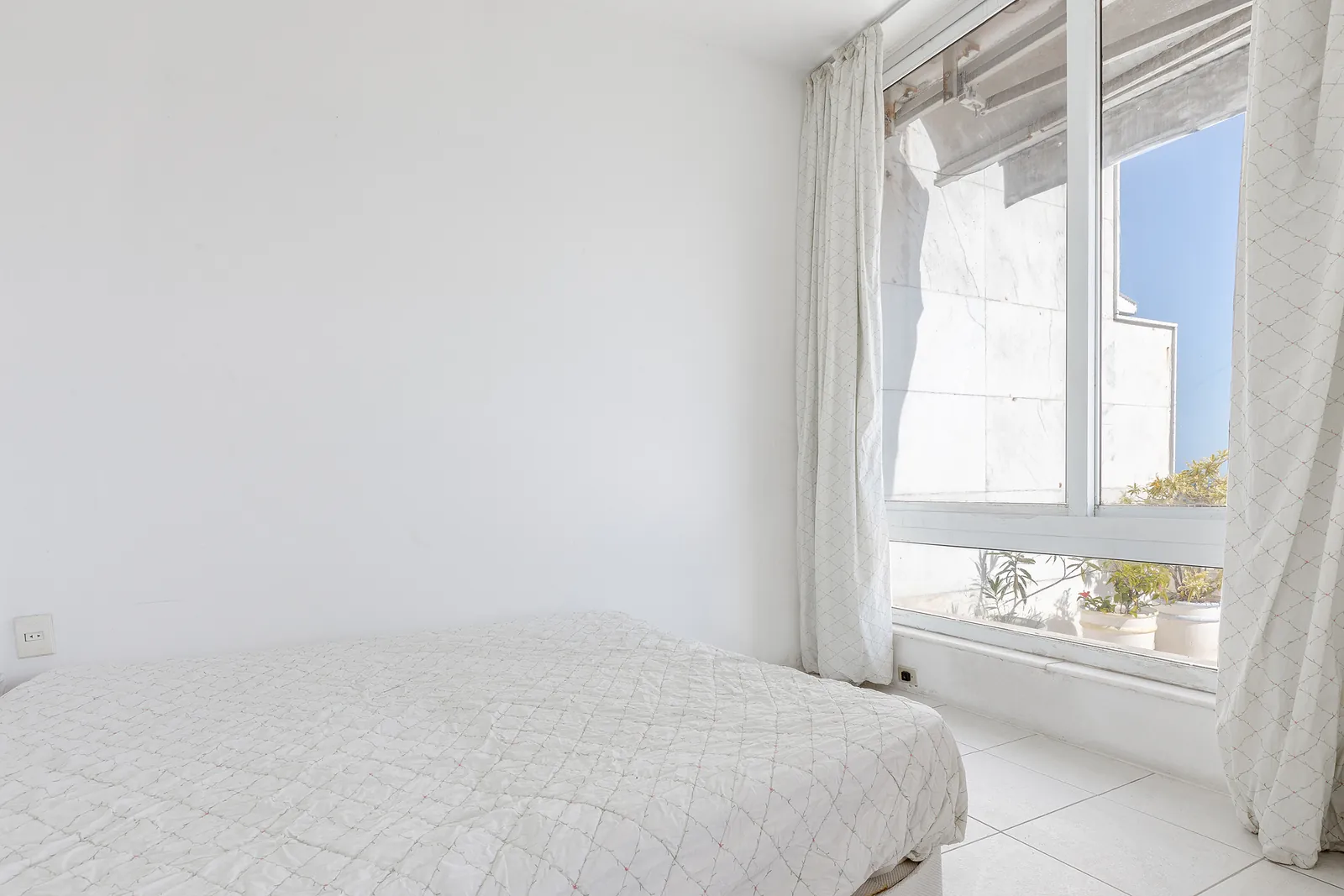 A room with the staircase rising beside the window