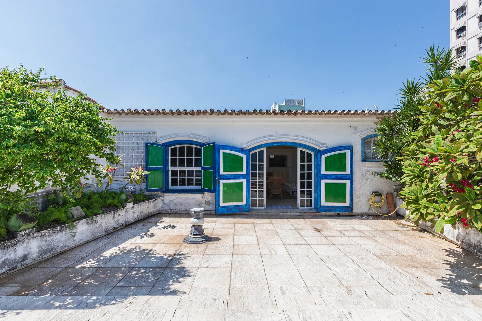 The rooftop house, its shuttered doors opening onto the terrace